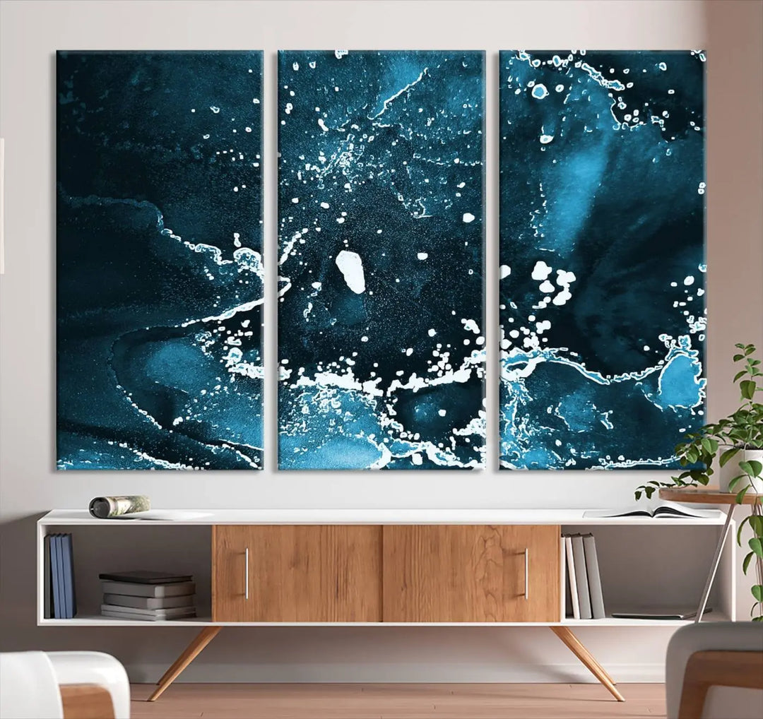 The Blue Marble Ink Splash Effect Wall Art Abstract Canvas Wall Art Print features a gallery-wrapped finish on museum-quality canvas with UV-protective coating, hanging elegantly in the room.