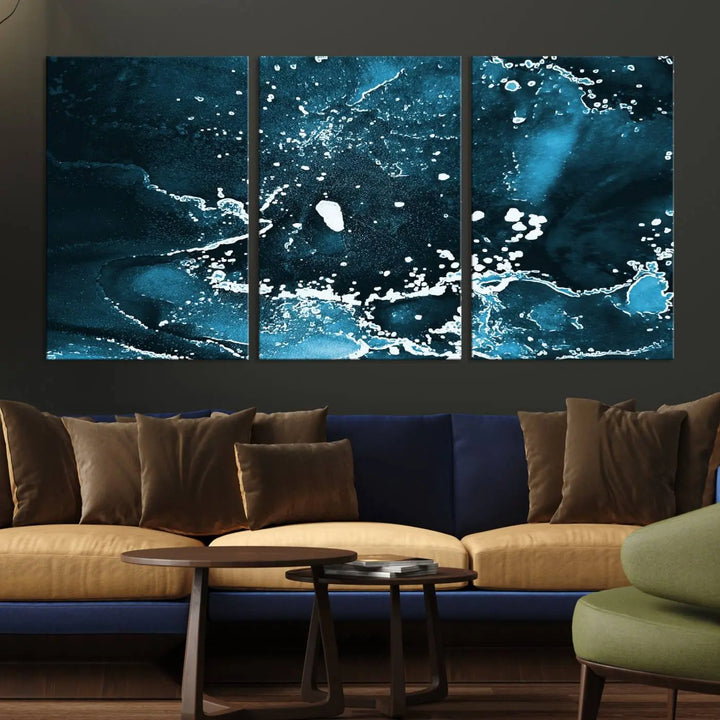 The Blue Marble Ink Splash Effect Wall Art Abstract Canvas Wall Art Print features a gallery-wrapped finish on museum-quality canvas with UV-protective coating, hanging elegantly in the room.