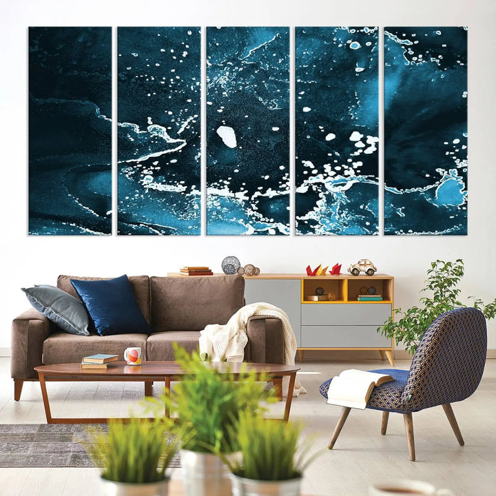 The Blue Marble Ink Splash Effect Wall Art Abstract Canvas Wall Art Print features a gallery-wrapped finish on museum-quality canvas with UV-protective coating, hanging elegantly in the room.