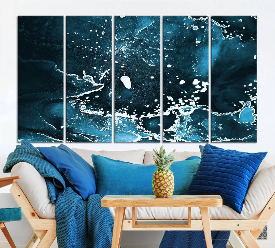 The Blue Marble Ink Splash Effect Wall Art Abstract Canvas Wall Art Print features a gallery-wrapped finish on museum-quality canvas with UV-protective coating, hanging elegantly in the room.