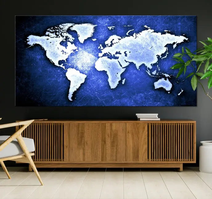 The living room features the Blue Metallic World Map Wall Art Canvas Print on a blue background, showcasing museum-quality canvases with a UV-protective coating, enhancing the modern decor.