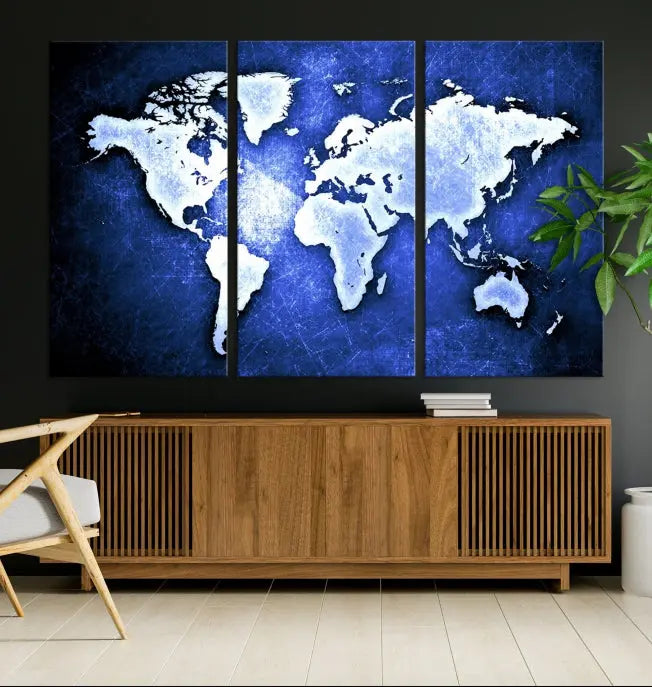 The living room features the Blue Metallic World Map Wall Art Canvas Print on a blue background, showcasing museum-quality canvases with a UV-protective coating, enhancing the modern decor.