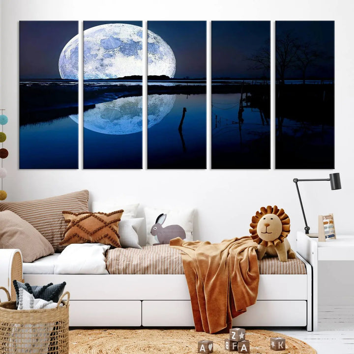 A mesmerizing Blue Moon Wall Art Canvas Print, depicting a lake landscape with a silhouetted tree, is beautifully presented on museum-quality canvas. This gallery-wrapped artwork, protected by a UV-coating to preserve its stunning details, stands out as an exquisite piece in the room.