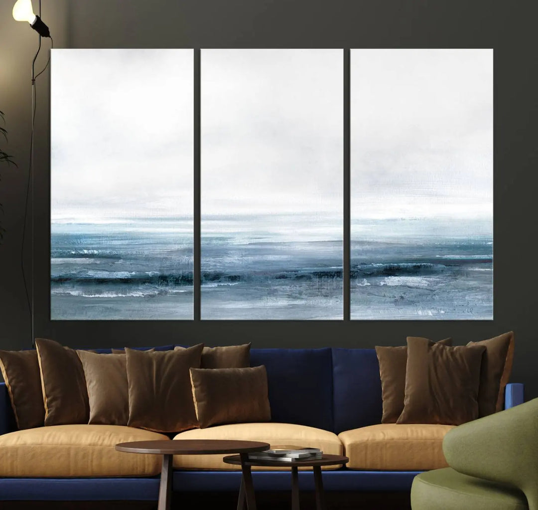 The Blue Ocean Abstract Artwork Wall Art Canvas Print, featuring museum-quality canvas with a gallery wrap and UV-protective coating, enhances the wall in a softly lit room.