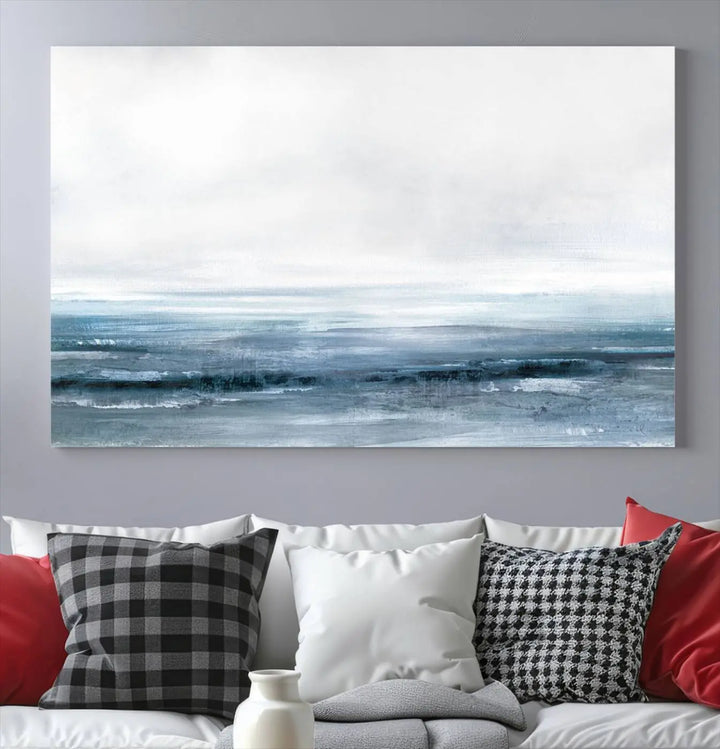 The Blue Ocean Abstract Artwork Wall Art Canvas Print, featuring museum-quality canvas with a gallery wrap and UV-protective coating, enhances the wall in a softly lit room.