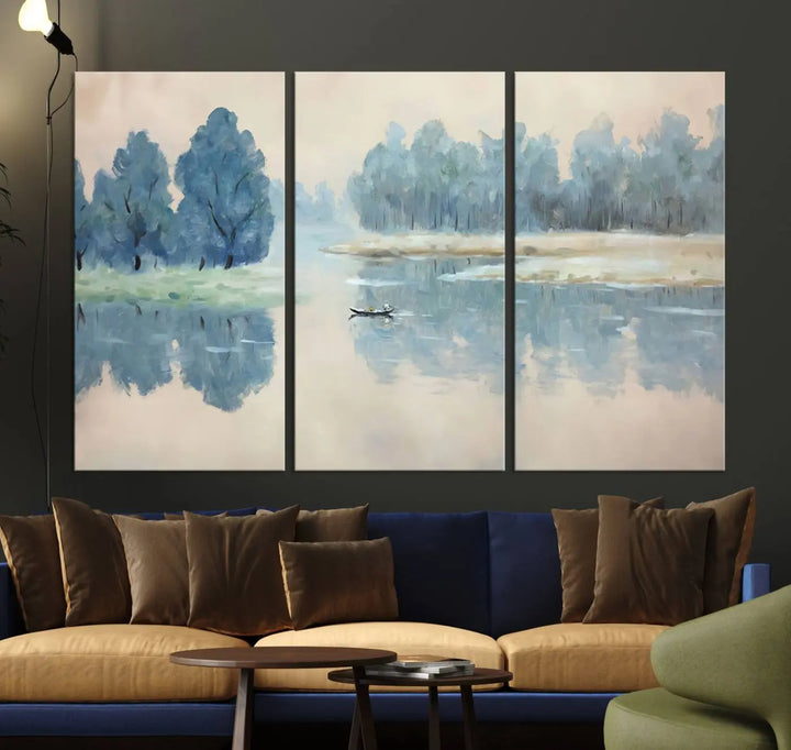 The triptych canvas print, "Blue Trees and Water Reflection Landscape," showcases a serene lake and boat scene through giclee printing. The blue trees reflecting on the water create a calming ambiance, making it an ideal choice for nature lovers.