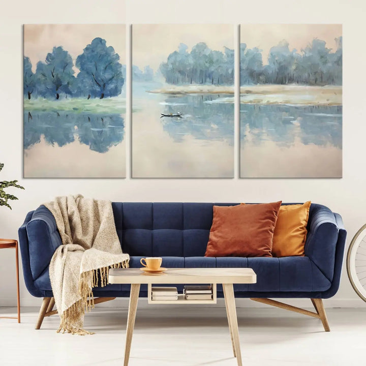 The triptych canvas print, "Blue Trees and Water Reflection Landscape," showcases a serene lake and boat scene through giclee printing. The blue trees reflecting on the water create a calming ambiance, making it an ideal choice for nature lovers.