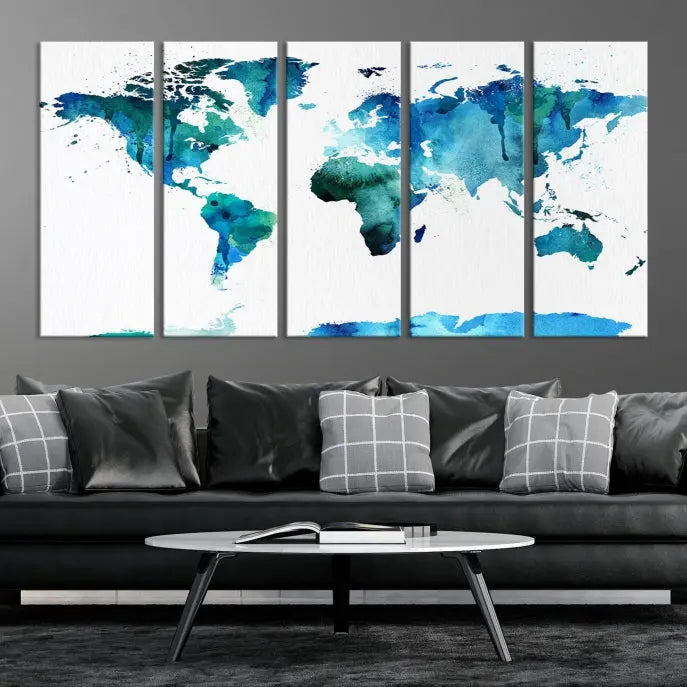 The Blue Watercolor World Map Wall Art Canvas Print features a multi-panel design in shades of blue and green, printed on museum-quality canvas with a UV-protective coating. It is ready to hang.