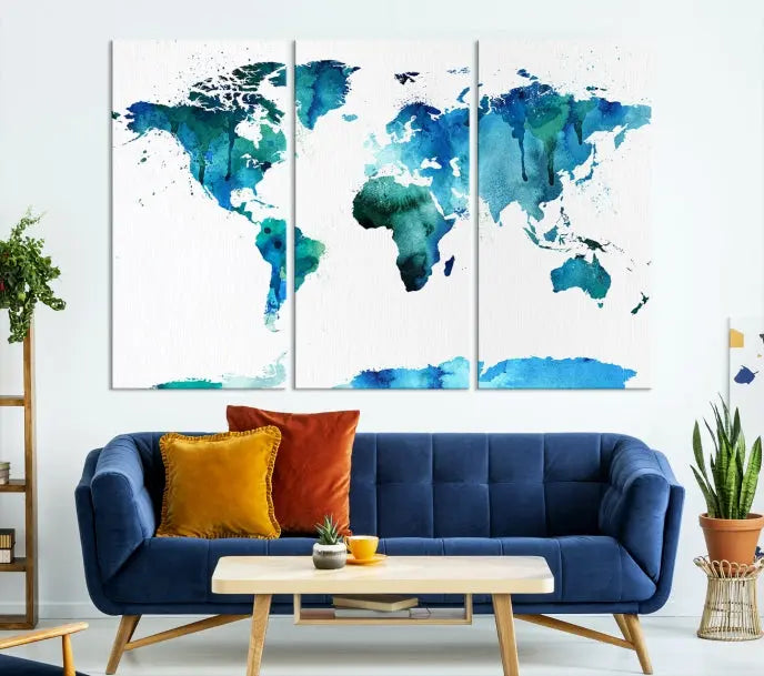 The Blue Watercolor World Map Wall Art Canvas Print features a multi-panel design in shades of blue and green, printed on museum-quality canvas with a UV-protective coating. It is ready to hang.