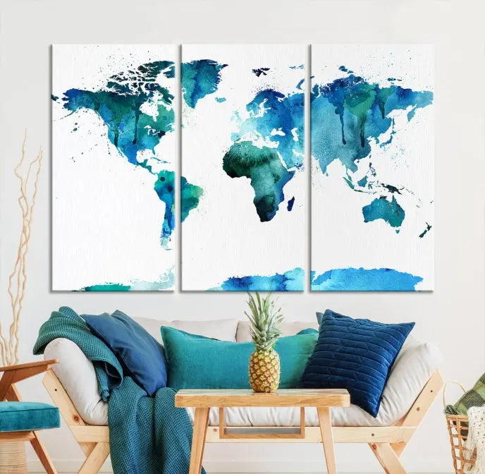 The Blue Watercolor World Map Wall Art Canvas Print features a multi-panel design in shades of blue and green, printed on museum-quality canvas with a UV-protective coating. It is ready to hang.