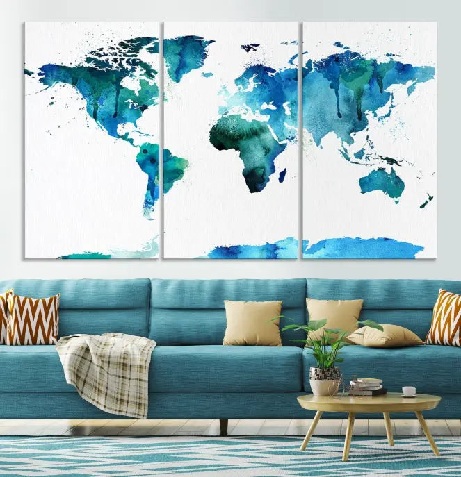 The Blue Watercolor World Map Wall Art Canvas Print features a multi-panel design in shades of blue and green, printed on museum-quality canvas with a UV-protective coating. It is ready to hang.