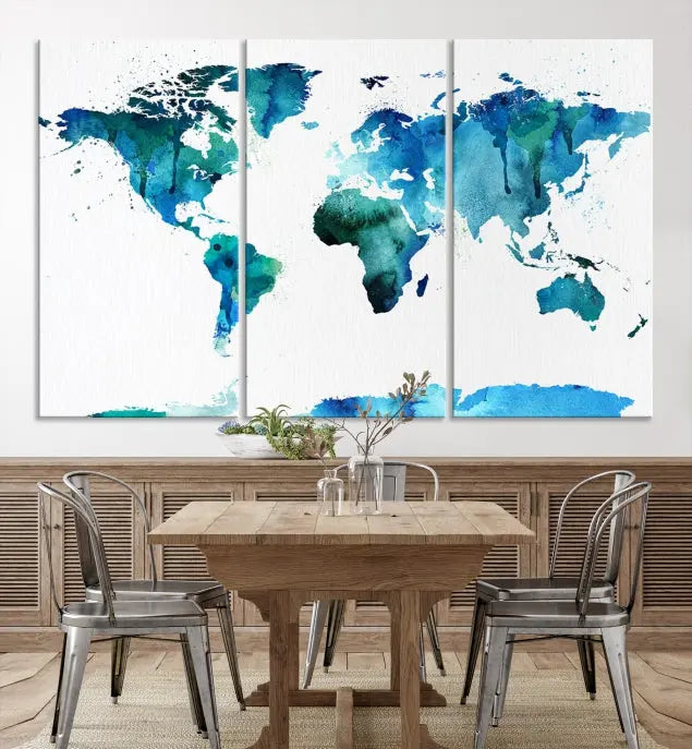 The Blue Watercolor World Map Wall Art Canvas Print features a multi-panel design in shades of blue and green, printed on museum-quality canvas with a UV-protective coating. It is ready to hang.