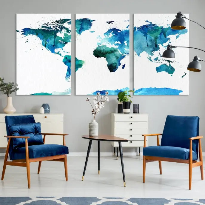 The Blue Watercolor World Map Wall Art Canvas Print features a multi-panel design in shades of blue and green, printed on museum-quality canvas with a UV-protective coating. It is ready to hang.