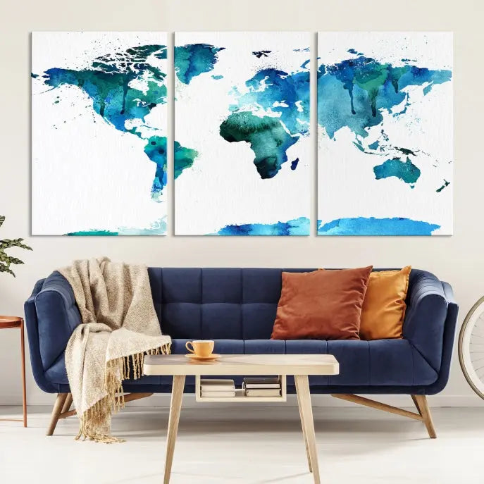 The Blue Watercolor World Map Wall Art Canvas Print features a multi-panel design in shades of blue and green, printed on museum-quality canvas with a UV-protective coating. It is ready to hang.