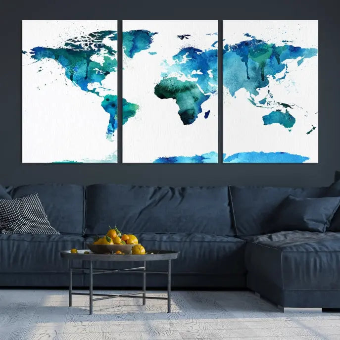 The Blue Watercolor World Map Wall Art Canvas Print features a multi-panel design in shades of blue and green, printed on museum-quality canvas with a UV-protective coating. It is ready to hang.