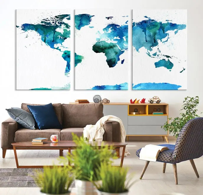 The Blue Watercolor World Map Wall Art Canvas Print features a multi-panel design in shades of blue and green, printed on museum-quality canvas with a UV-protective coating. It is ready to hang.