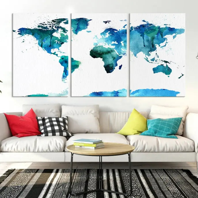 The Blue Watercolor World Map Wall Art Canvas Print features a multi-panel design in shades of blue and green, printed on museum-quality canvas with a UV-protective coating. It is ready to hang.