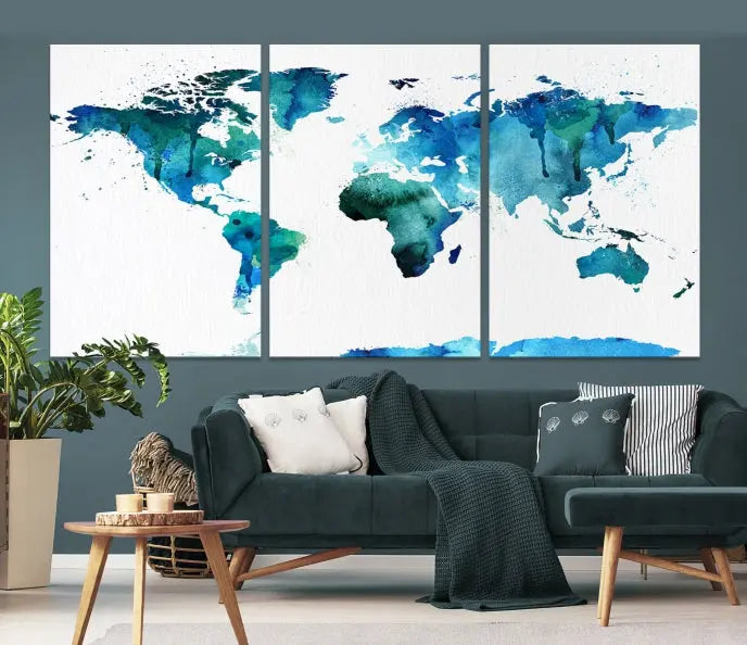 The Blue Watercolor World Map Wall Art Canvas Print features a multi-panel design in shades of blue and green, printed on museum-quality canvas with a UV-protective coating. It is ready to hang.