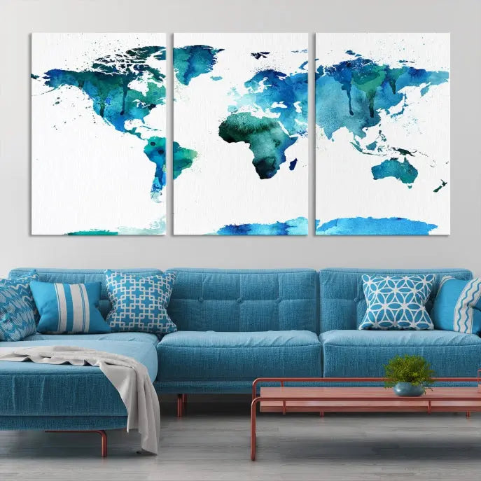 The Blue Watercolor World Map Wall Art Canvas Print features a multi-panel design in shades of blue and green, printed on museum-quality canvas with a UV-protective coating. It is ready to hang.