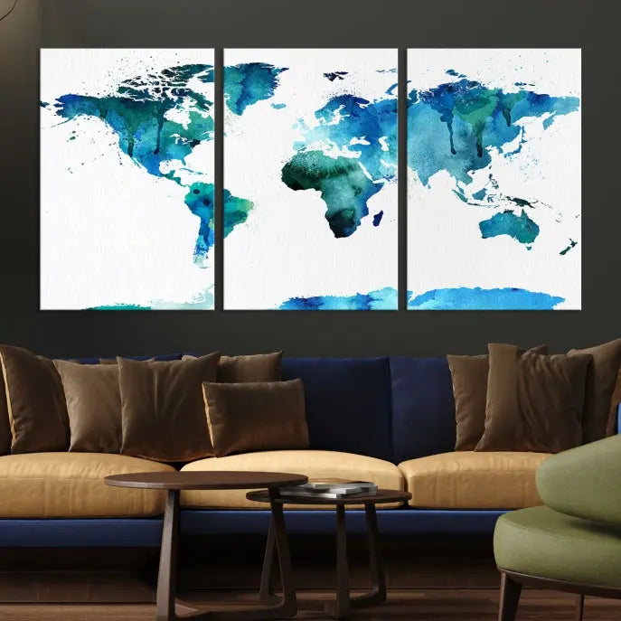 The Blue Watercolor World Map Wall Art Canvas Print features a multi-panel design in shades of blue and green, printed on museum-quality canvas with a UV-protective coating. It is ready to hang.