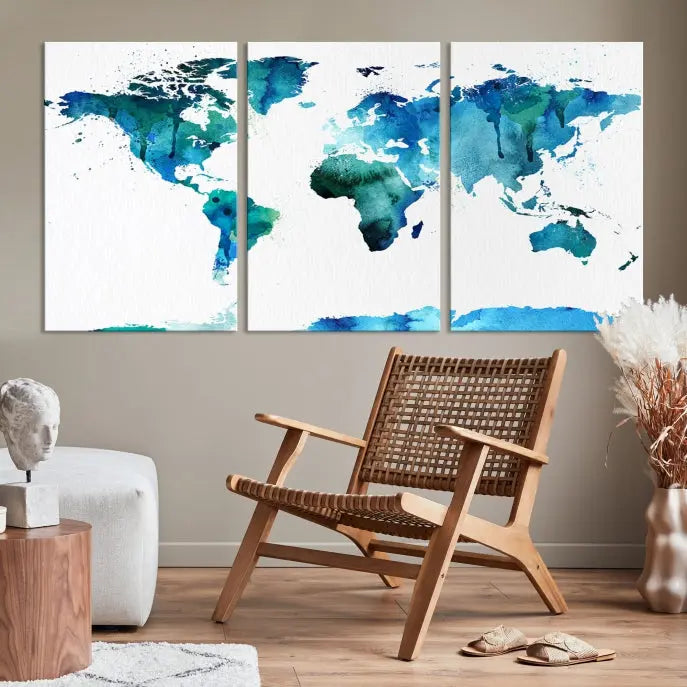 The Blue Watercolor World Map Wall Art Canvas Print features a multi-panel design in shades of blue and green, printed on museum-quality canvas with a UV-protective coating. It is ready to hang.