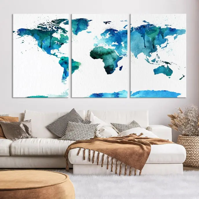 The Blue Watercolor World Map Wall Art Canvas Print features a multi-panel design in shades of blue and green, printed on museum-quality canvas with a UV-protective coating. It is ready to hang.