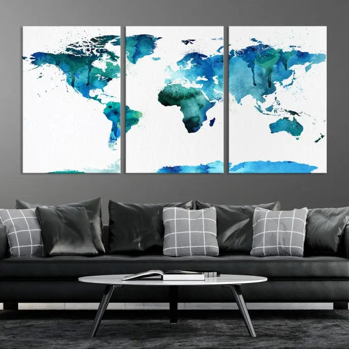 The Blue Watercolor World Map Wall Art Canvas Print features a multi-panel design in shades of blue and green, printed on museum-quality canvas with a UV-protective coating. It is ready to hang.