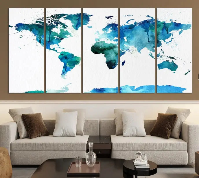 The Blue Watercolor World Map Wall Art Canvas Print features a multi-panel design in shades of blue and green, printed on museum-quality canvas with a UV-protective coating. It is ready to hang.