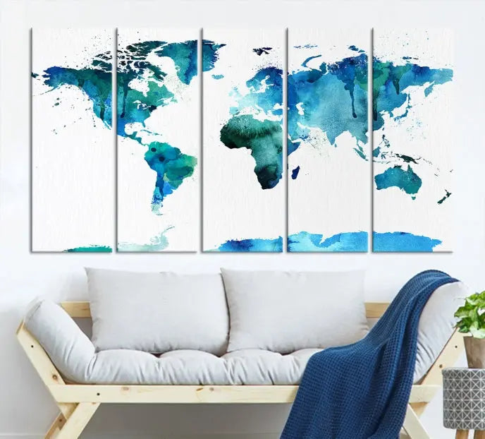 The Blue Watercolor World Map Wall Art Canvas Print features a multi-panel design in shades of blue and green, printed on museum-quality canvas with a UV-protective coating. It is ready to hang.