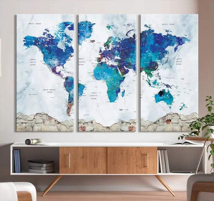 The living room features the striking Blue World Map Canvas Print—a five-panel abstract world map artwork on museum-quality canvas that is ready to hang.