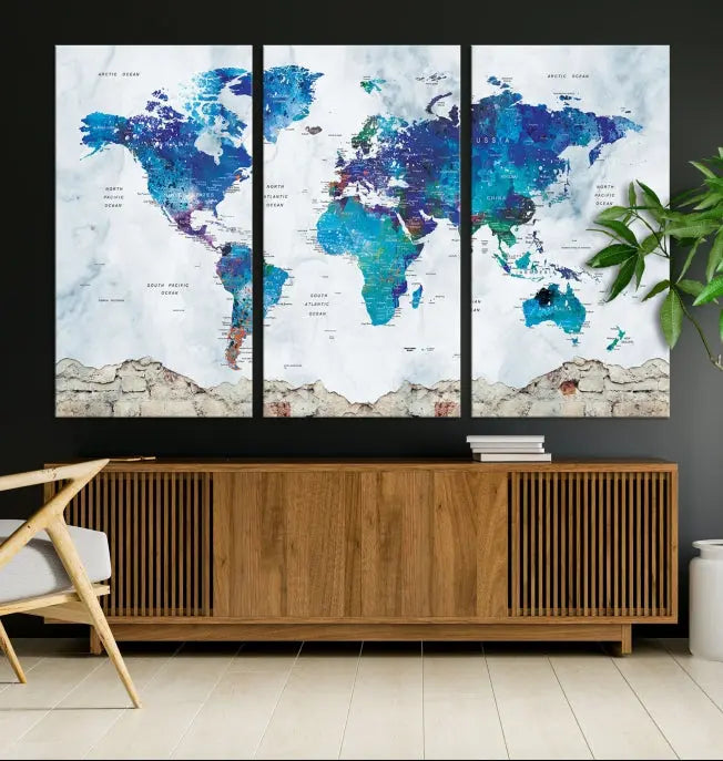 The living room features the striking Blue World Map Canvas Print—a five-panel abstract world map artwork on museum-quality canvas that is ready to hang.