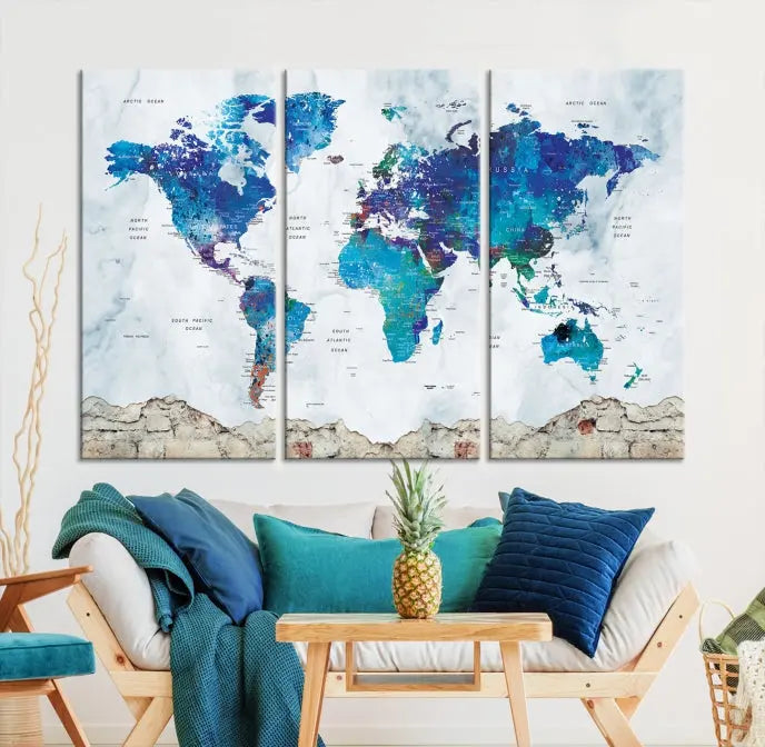 The living room features the striking Blue World Map Canvas Print—a five-panel abstract world map artwork on museum-quality canvas that is ready to hang.