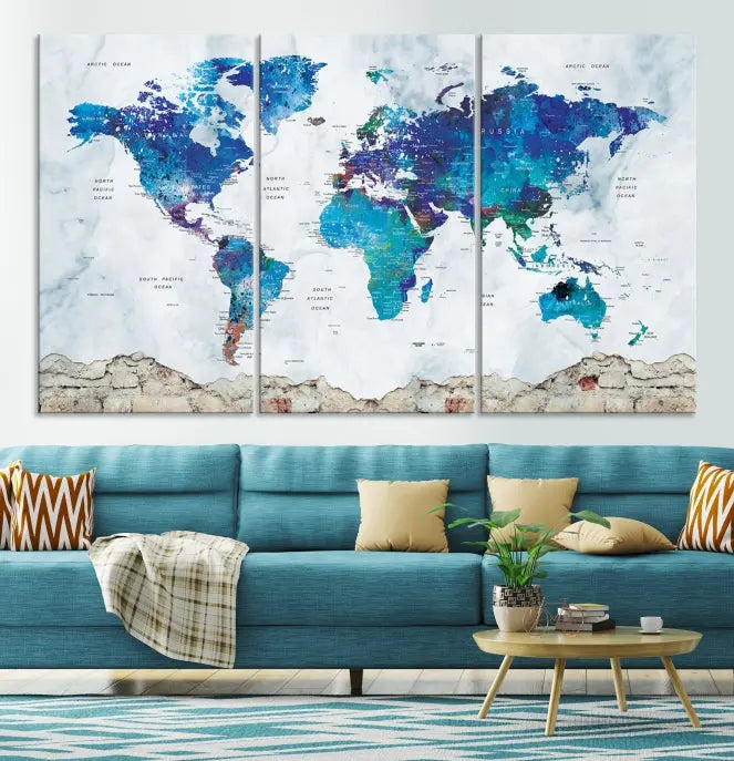 The living room features the striking Blue World Map Canvas Print—a five-panel abstract world map artwork on museum-quality canvas that is ready to hang.