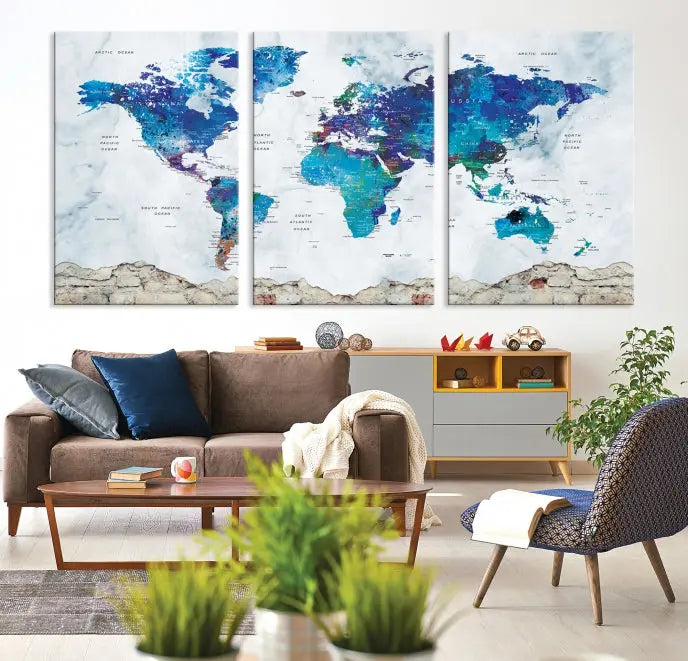 The living room features the striking Blue World Map Canvas Print—a five-panel abstract world map artwork on museum-quality canvas that is ready to hang.