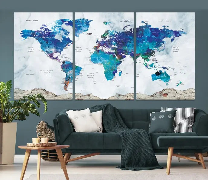 The living room features the striking Blue World Map Canvas Print—a five-panel abstract world map artwork on museum-quality canvas that is ready to hang.