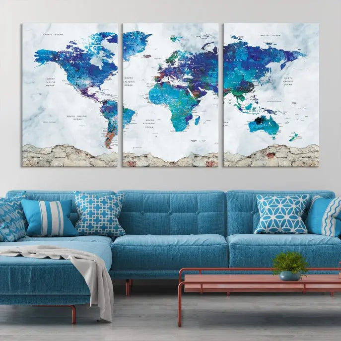 The living room features the striking Blue World Map Canvas Print—a five-panel abstract world map artwork on museum-quality canvas that is ready to hang.