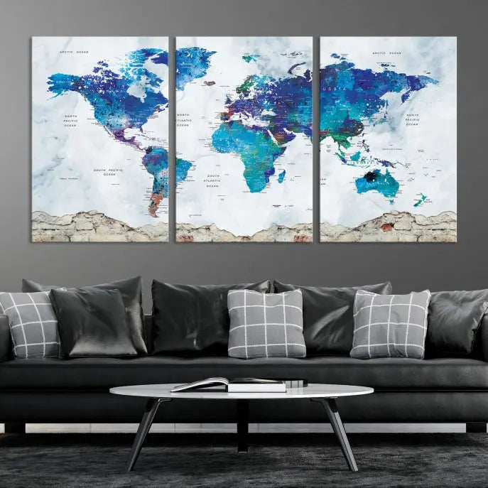 The living room features the striking Blue World Map Canvas Print—a five-panel abstract world map artwork on museum-quality canvas that is ready to hang.