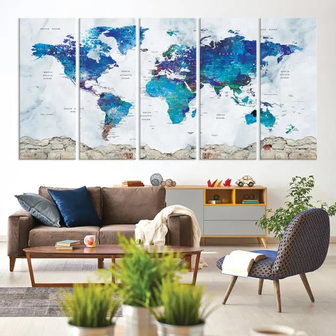 The living room features the striking Blue World Map Canvas Print—a five-panel abstract world map artwork on museum-quality canvas that is ready to hang.