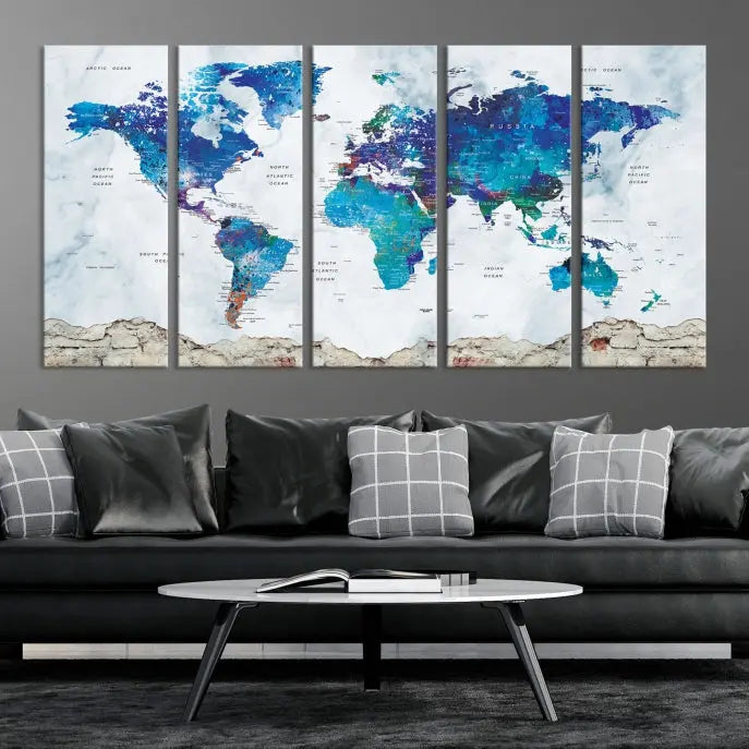 The living room features the striking Blue World Map Canvas Print—a five-panel abstract world map artwork on museum-quality canvas that is ready to hang.