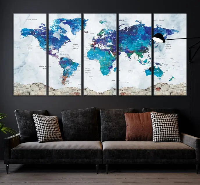 The living room features the striking Blue World Map Canvas Print—a five-panel abstract world map artwork on museum-quality canvas that is ready to hang.