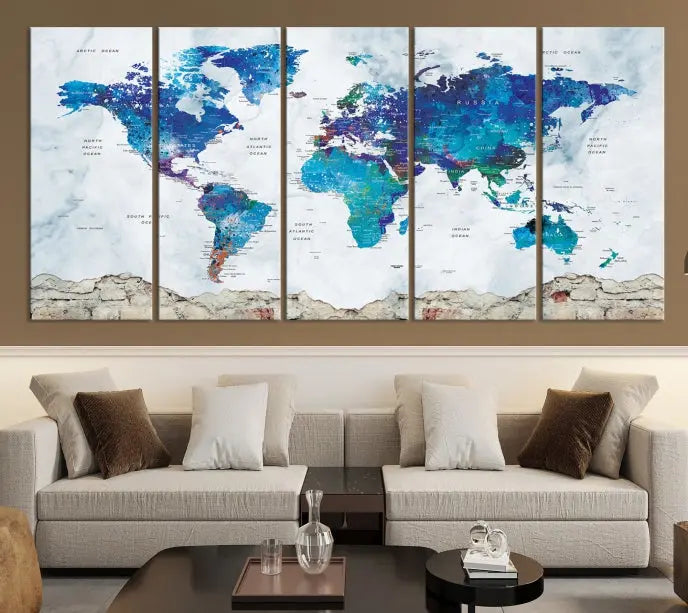 The living room features the striking Blue World Map Canvas Print—a five-panel abstract world map artwork on museum-quality canvas that is ready to hang.