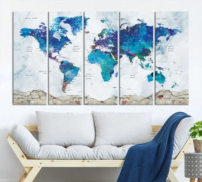 The living room features the striking Blue World Map Canvas Print—a five-panel abstract world map artwork on museum-quality canvas that is ready to hang.