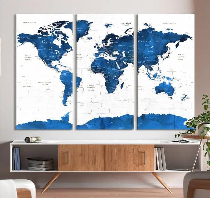 The Blue World Map Wall Art Canvas Print features three panels with blue oceans set against a white backdrop, gallery wrapped for a sleek appearance. This ready-to-hang piece is crafted on museum-quality canvas to bring elegance to any room.