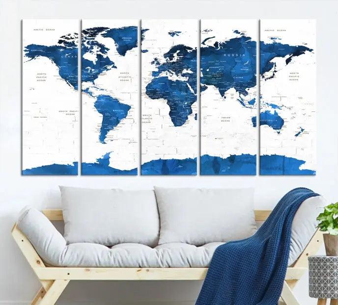 The Blue World Map Wall Art Canvas Print features three panels with blue oceans set against a white backdrop, gallery wrapped for a sleek appearance. This ready-to-hang piece is crafted on museum-quality canvas to bring elegance to any room.