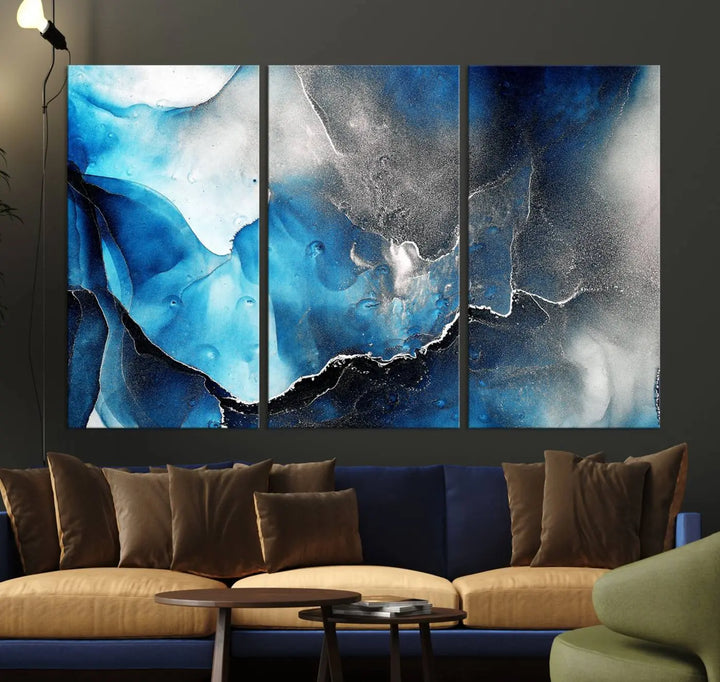 The Blue and Black Marble Fluid Effect Wall Art Abstract Canvas Prints feature three dynamic swirling patterns in blue, black, and white. Crafted on museum-quality canvases and enhanced with a UV-protective coating, these prints maintain their vibrant allure over time.