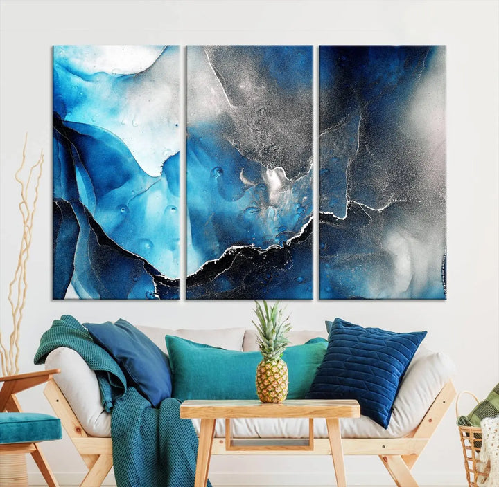 The Blue and Black Marble Fluid Effect Wall Art Abstract Canvas Prints feature three dynamic swirling patterns in blue, black, and white. Crafted on museum-quality canvases and enhanced with a UV-protective coating, these prints maintain their vibrant allure over time.