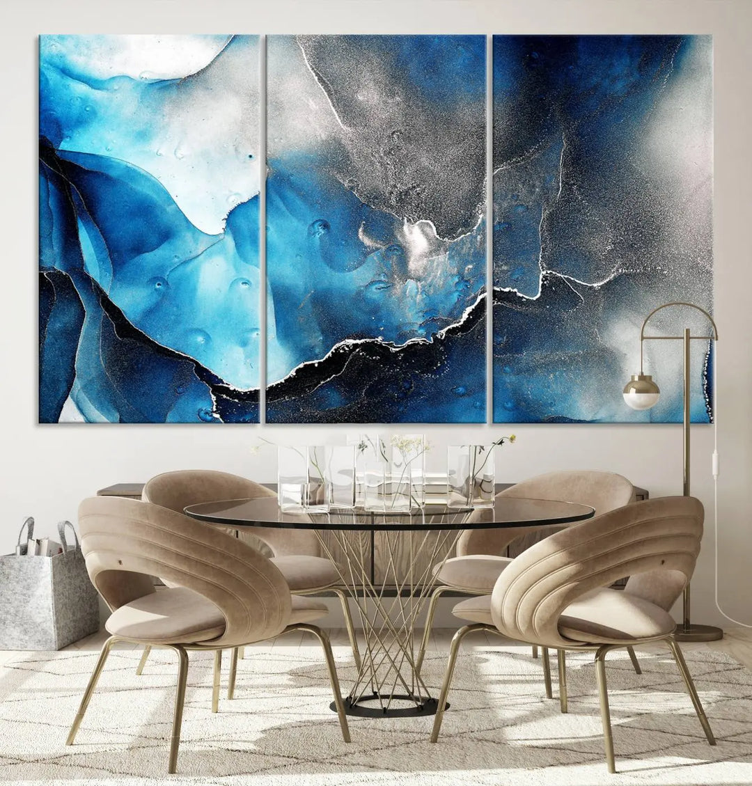 The Blue and Black Marble Fluid Effect Wall Art Abstract Canvas Prints feature three dynamic swirling patterns in blue, black, and white. Crafted on museum-quality canvases and enhanced with a UV-protective coating, these prints maintain their vibrant allure over time.