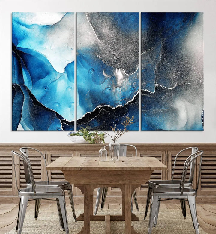 The Blue and Black Marble Fluid Effect Wall Art Abstract Canvas Prints feature three dynamic swirling patterns in blue, black, and white. Crafted on museum-quality canvases and enhanced with a UV-protective coating, these prints maintain their vibrant allure over time.