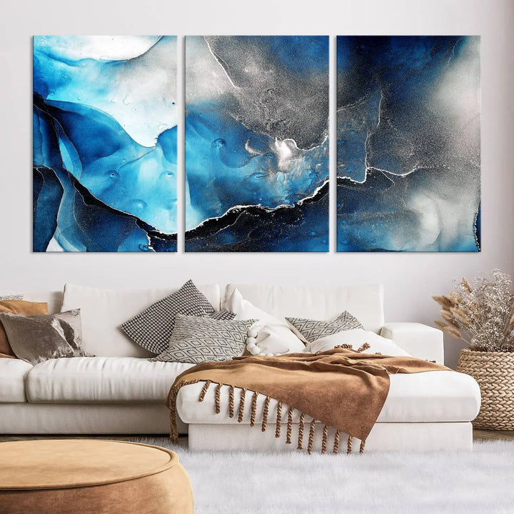 The Blue and Black Marble Fluid Effect Wall Art Abstract Canvas Prints feature three dynamic swirling patterns in blue, black, and white. Crafted on museum-quality canvases and enhanced with a UV-protective coating, these prints maintain their vibrant allure over time.