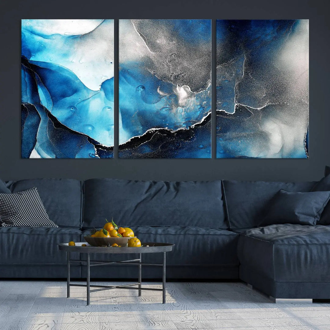 The Blue and Black Marble Fluid Effect Wall Art Abstract Canvas Prints feature three dynamic swirling patterns in blue, black, and white. Crafted on museum-quality canvases and enhanced with a UV-protective coating, these prints maintain their vibrant allure over time.